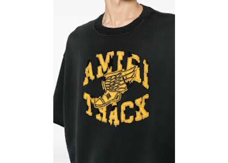 Amiri Mens Track T-Shirt in a faded black color with a yellow distressed graphic.