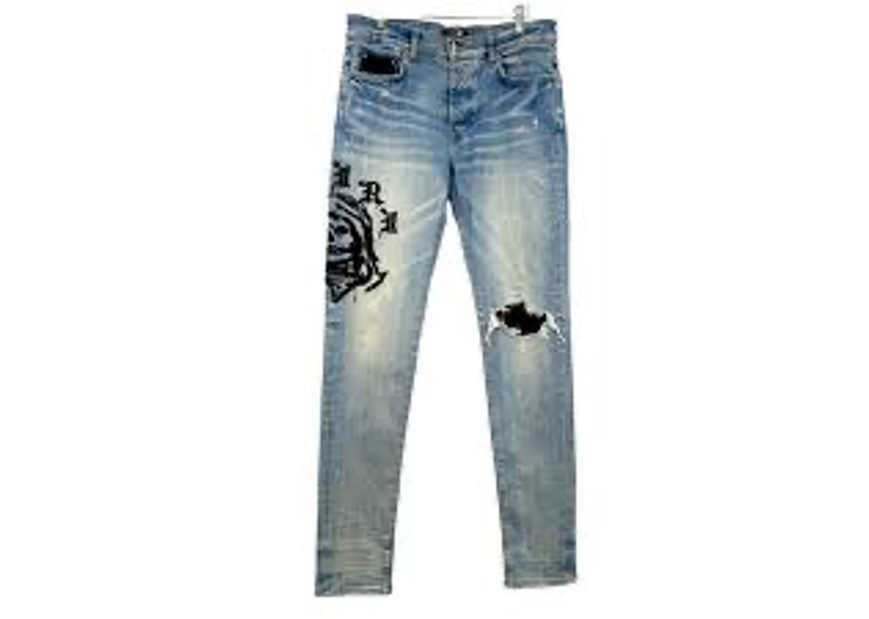 Amiri Wes Lang Reaper Denim logo jeans feature a light blue wash and a large black embroidered reaper graphic.