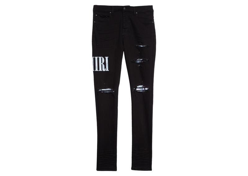 Amiri Mens Black Tie-Dye Core Logo Denim Jeans featuring distressed ripped detailing and a spell-out logo patch